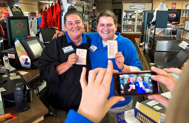 Kristi Williams, left, and Kelly Blount, both sales associates at the Trex Mart in Dearborn, Missouri, pose for a cell phone photograph, Thursday, November 29, 2012, holding a paper Powerball receipt stating one of the national winners purchased a winning lottery ticket inside the gas station. (David Eulitt/Kansas City Star/MCT)