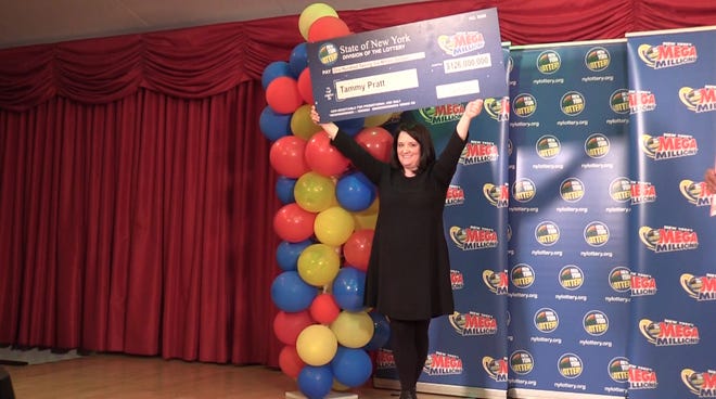 Tammy Pratt of South Fallsburg is the winner of a $126 million jackpot in Mega millions. Pratt, a real estate broker, received her check Wednesday from the New York Lottery's Yolanda Vega. MEREDITH ZARITHENY/TIMES HERALD-RECORD
